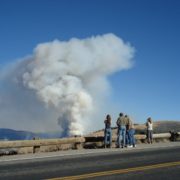 Community members watching a nearby fire